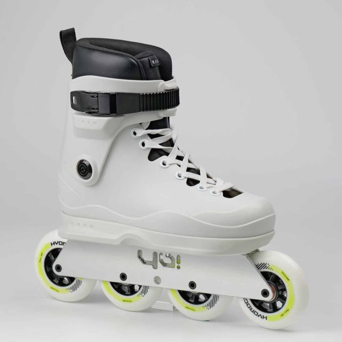 A white inline skate boot Themskates with black accents and white Rollerblade Hydrogen wheels and Sago UFS 90 frames.
