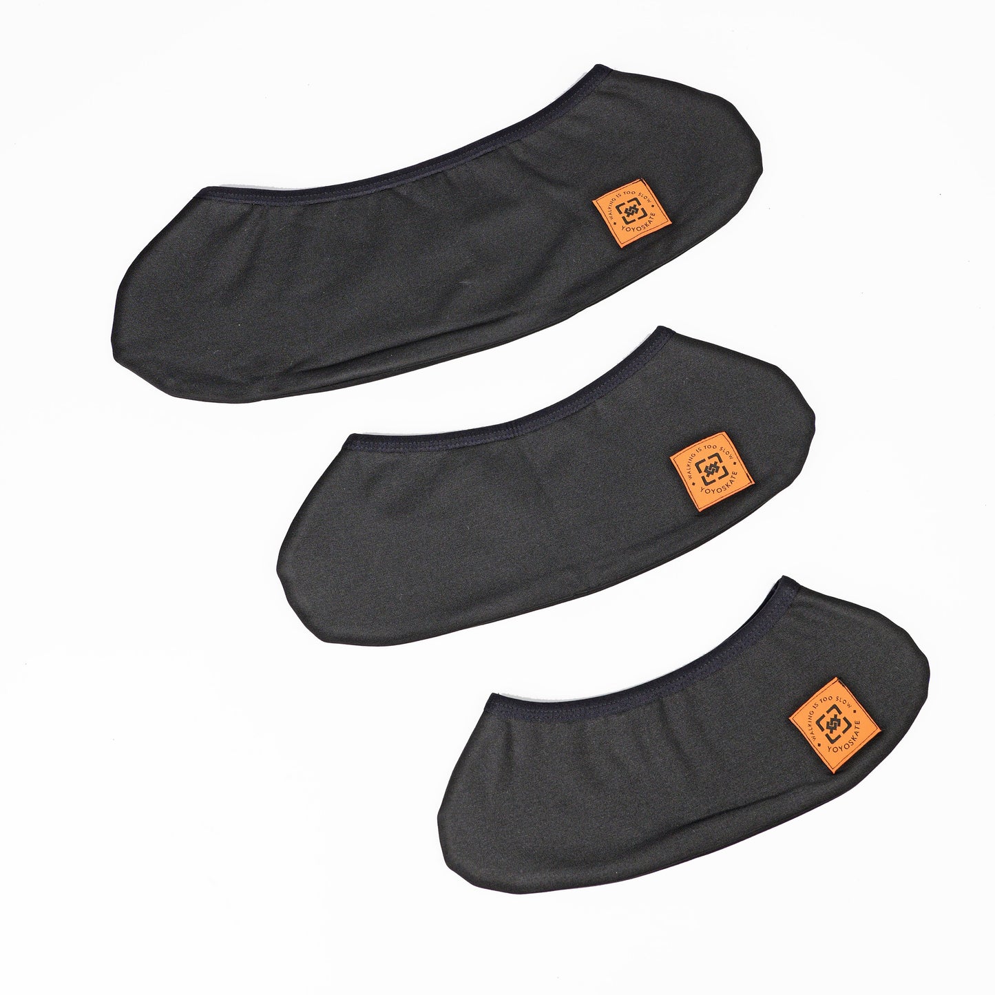 Three black whee covers arranged diagonally on a white background, each featuring a small orange square patch with a stylized logo.